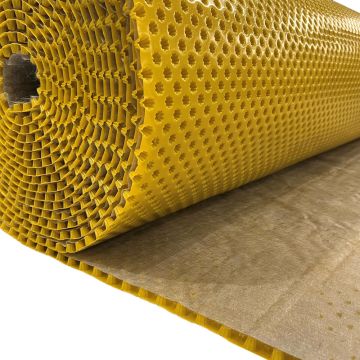 A roll of bright yellow perforated foam mat with a brown backing sheet partially unrolled, shown on a white background.